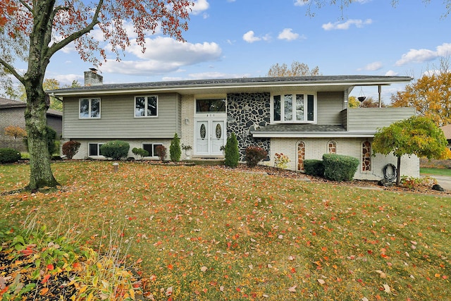 raised ranch with a front yard