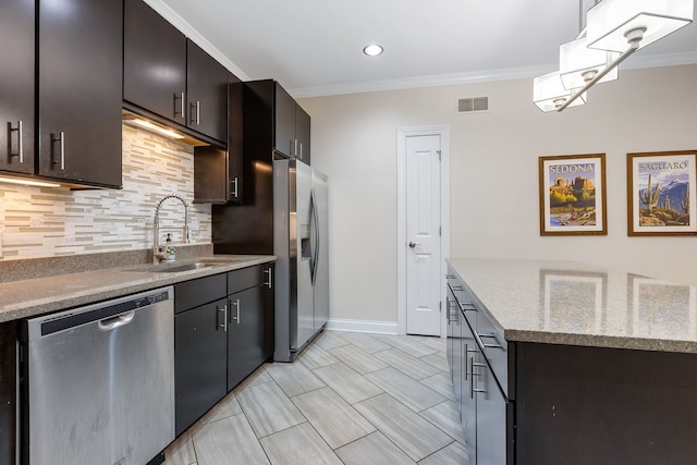 kitchen with sink, crown molding, decorative backsplash, dark brown cabinets, and appliances with stainless steel finishes