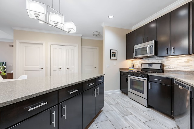 kitchen with appliances with stainless steel finishes, tasteful backsplash, light stone counters, crown molding, and hanging light fixtures