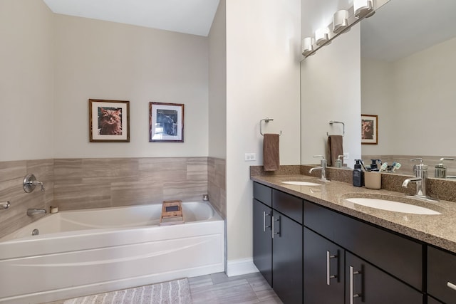 bathroom with a washtub and vanity