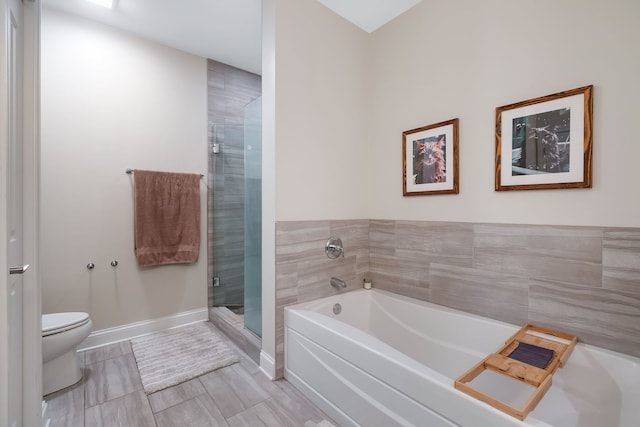 bathroom with toilet and shower with separate bathtub