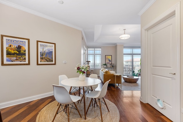 dining area with crown molding and dark hardwood / wood-style floors