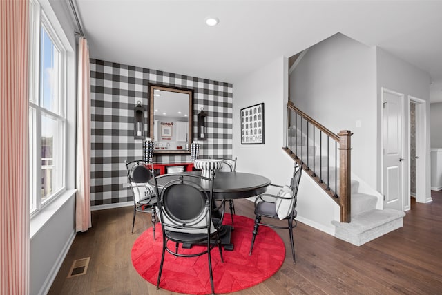 dining room featuring dark hardwood / wood-style flooring and plenty of natural light