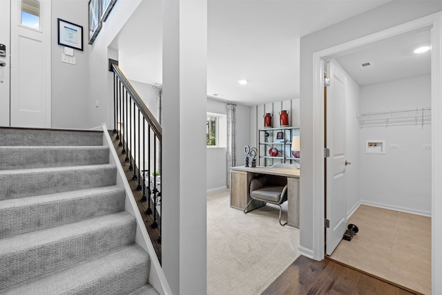 stairs featuring hardwood / wood-style floors