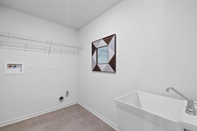 clothes washing area featuring hookup for a gas dryer, sink, light tile patterned flooring, and washer hookup