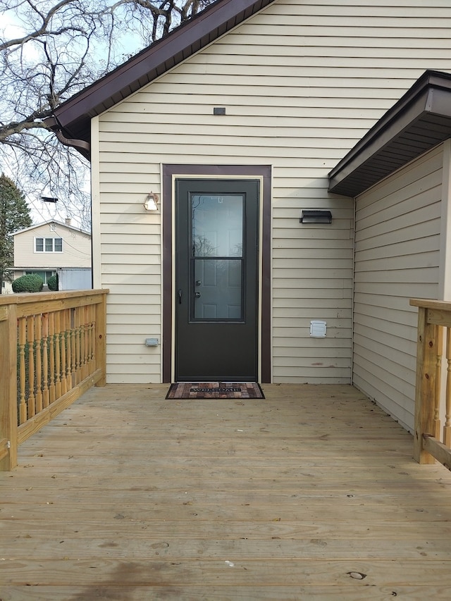 view of exterior entry with a wooden deck