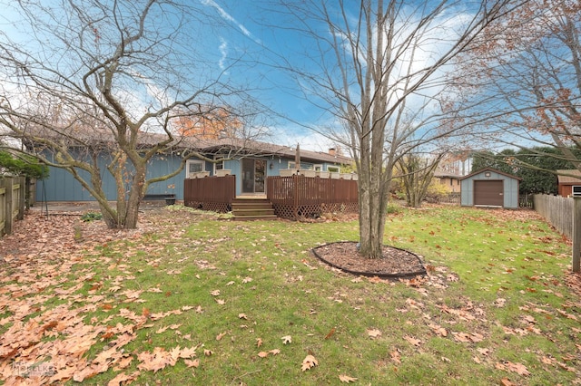 view of yard with a garage, an outdoor structure, and a deck