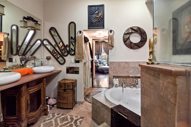 bathroom featuring vanity and a relaxing tiled tub