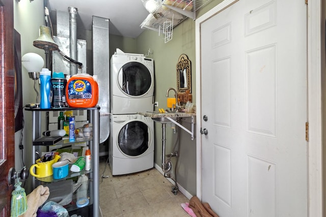 laundry area featuring stacked washer and dryer and sink