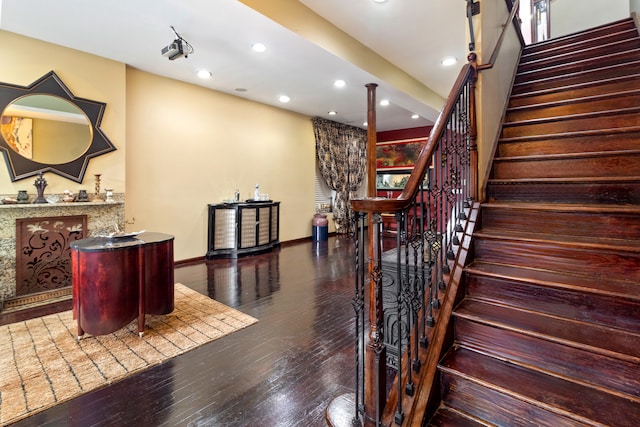 stairs featuring hardwood / wood-style flooring and ornate columns