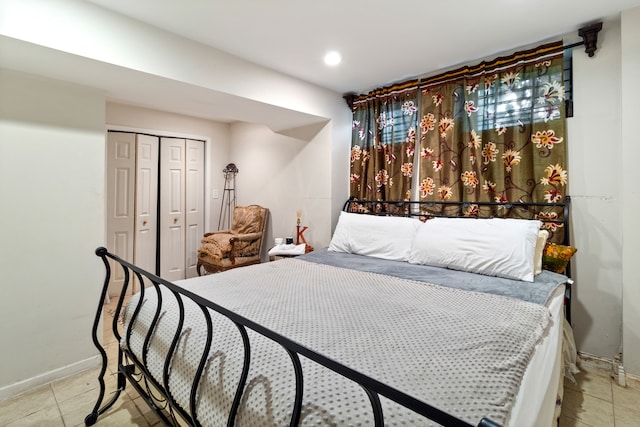 tiled bedroom featuring a closet