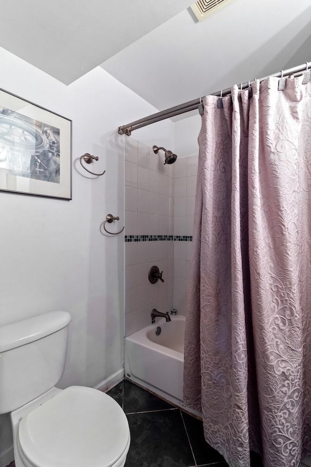 bathroom featuring tile patterned floors, toilet, and shower / tub combo