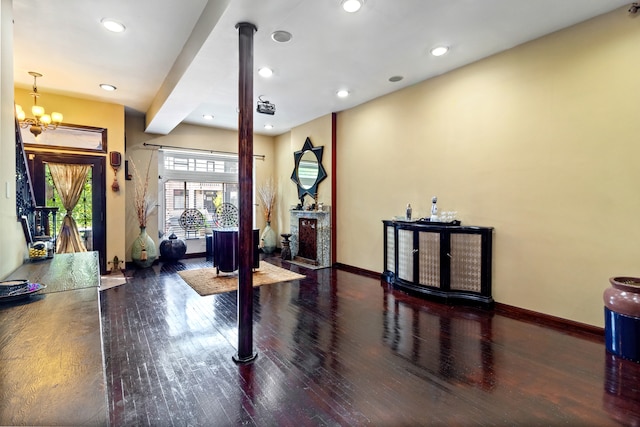 entryway with a notable chandelier and dark wood-type flooring