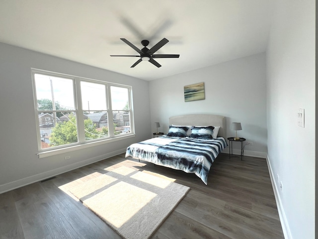 bedroom with ceiling fan and dark hardwood / wood-style flooring