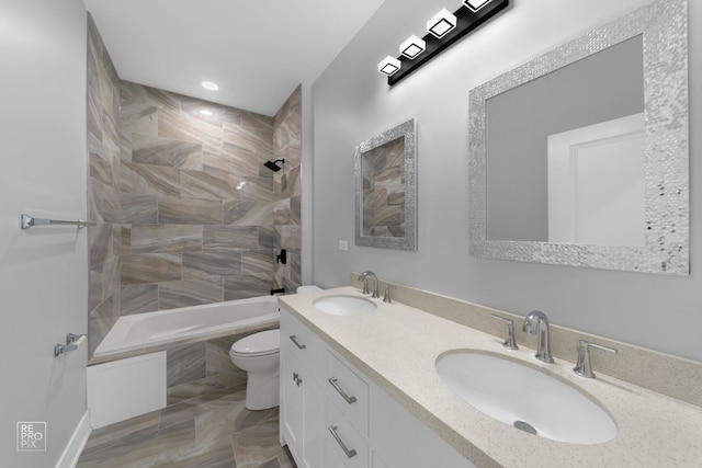 full bathroom with tile patterned flooring, vanity, toilet, and tiled shower / bath