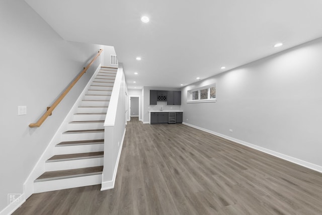 interior space with dark hardwood / wood-style flooring and bar area