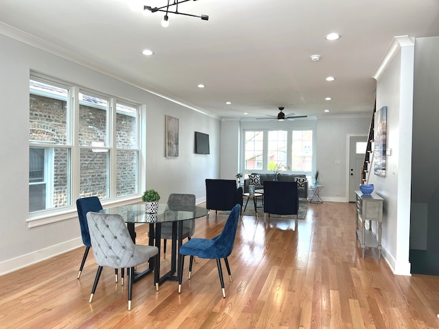 dining space with ceiling fan, light hardwood / wood-style flooring, and ornamental molding