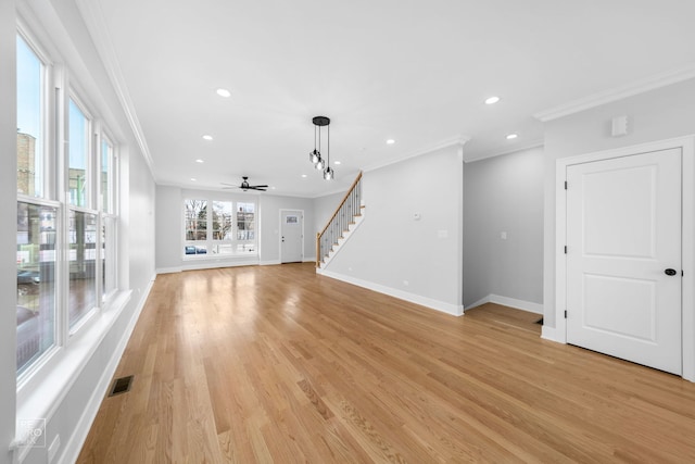 unfurnished living room featuring ceiling fan, light hardwood / wood-style floors, and ornamental molding