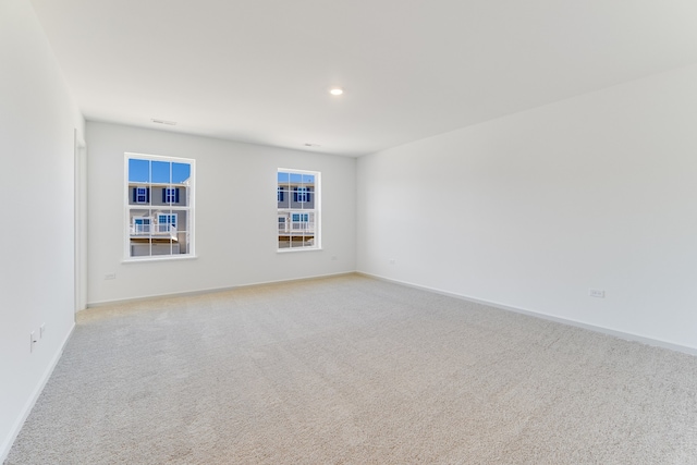 unfurnished room with light carpet