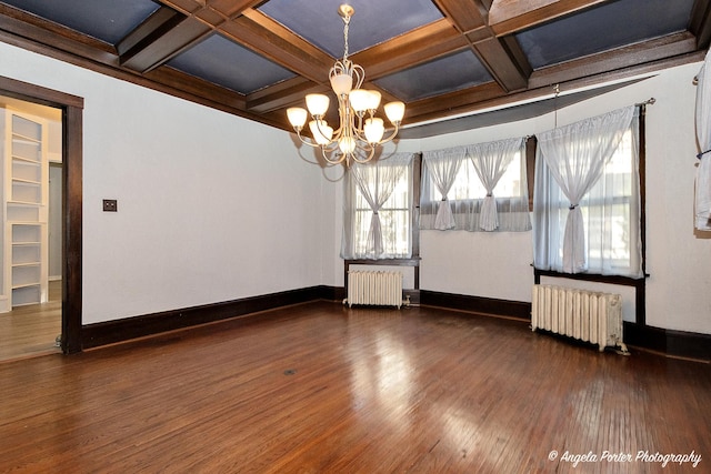 unfurnished room featuring a notable chandelier, dark hardwood / wood-style flooring, radiator, and coffered ceiling