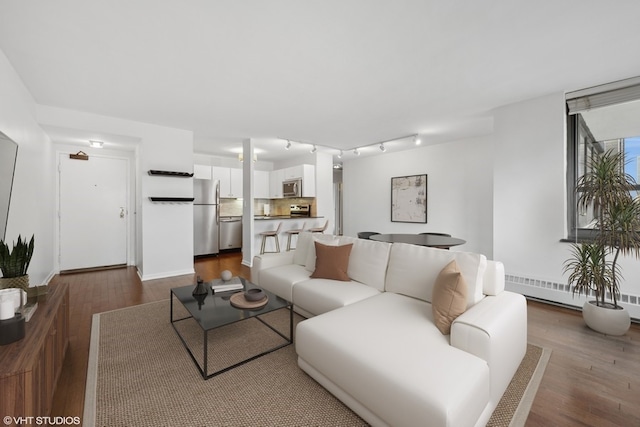 living room featuring dark hardwood / wood-style floors and baseboard heating