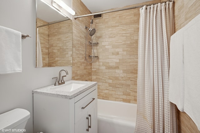 full bathroom featuring shower / bath combo, vanity, and toilet