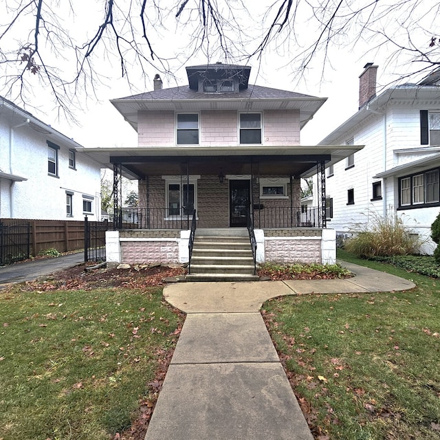 view of front of house featuring a porch and a front yard