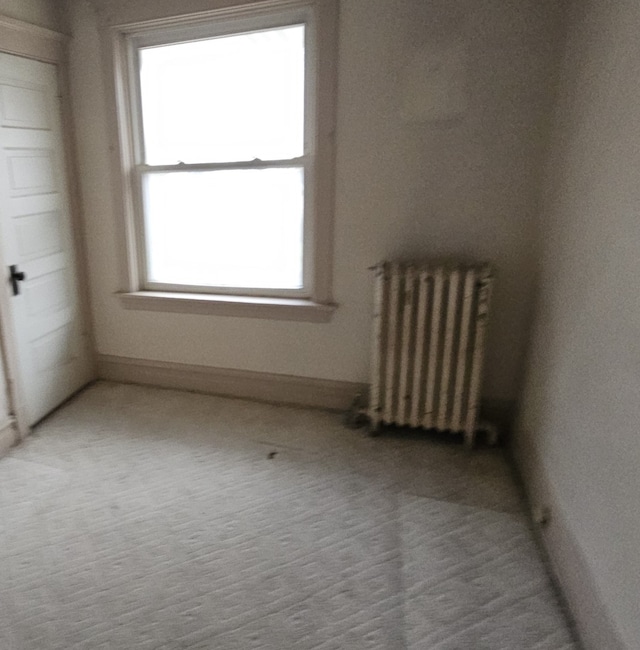 carpeted spare room with radiator