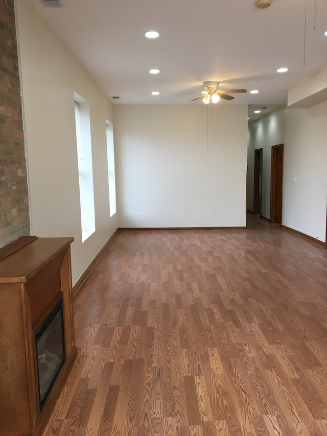 unfurnished living room with hardwood / wood-style floors and ceiling fan