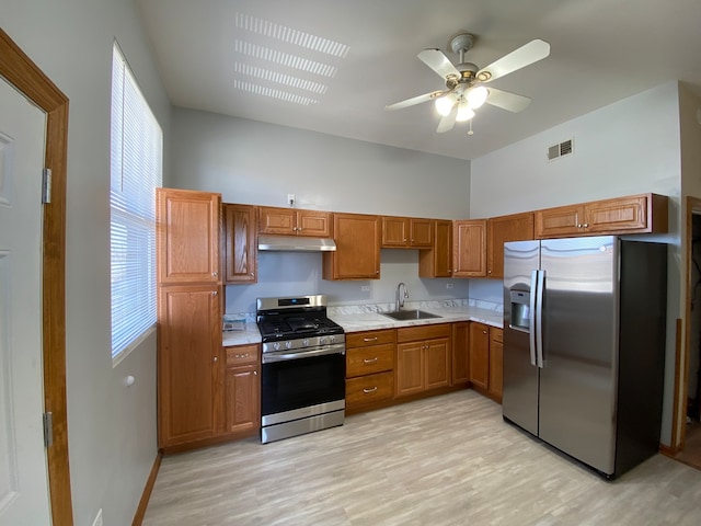 kitchen with ceiling fan, sink, light hardwood / wood-style floors, and appliances with stainless steel finishes