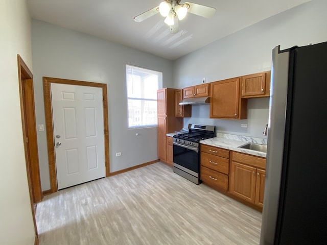 kitchen featuring ceiling fan, light hardwood / wood-style flooring, stainless steel appliances, and sink