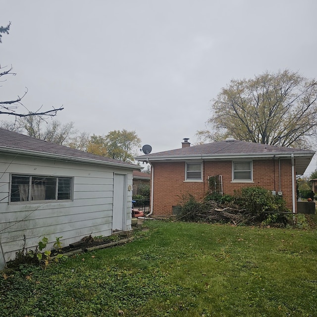 rear view of house featuring a lawn