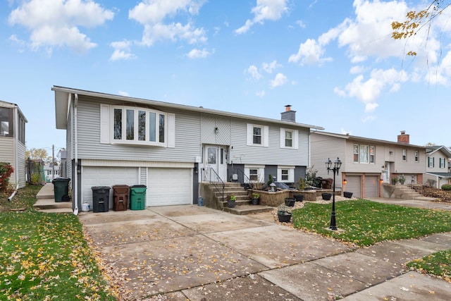 rear view of property with a lawn and a garage