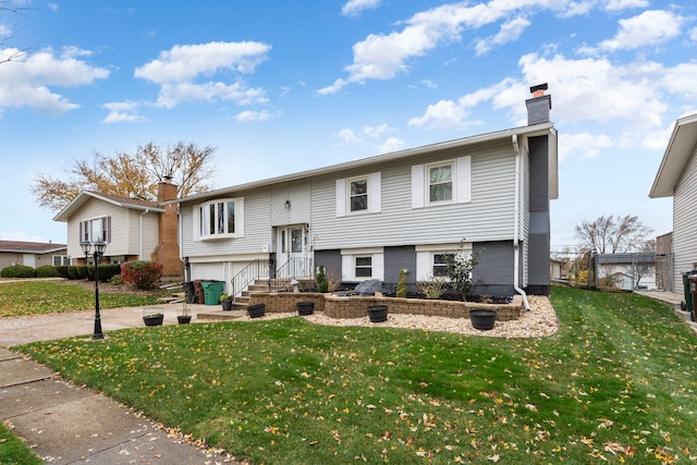 bi-level home with a front lawn