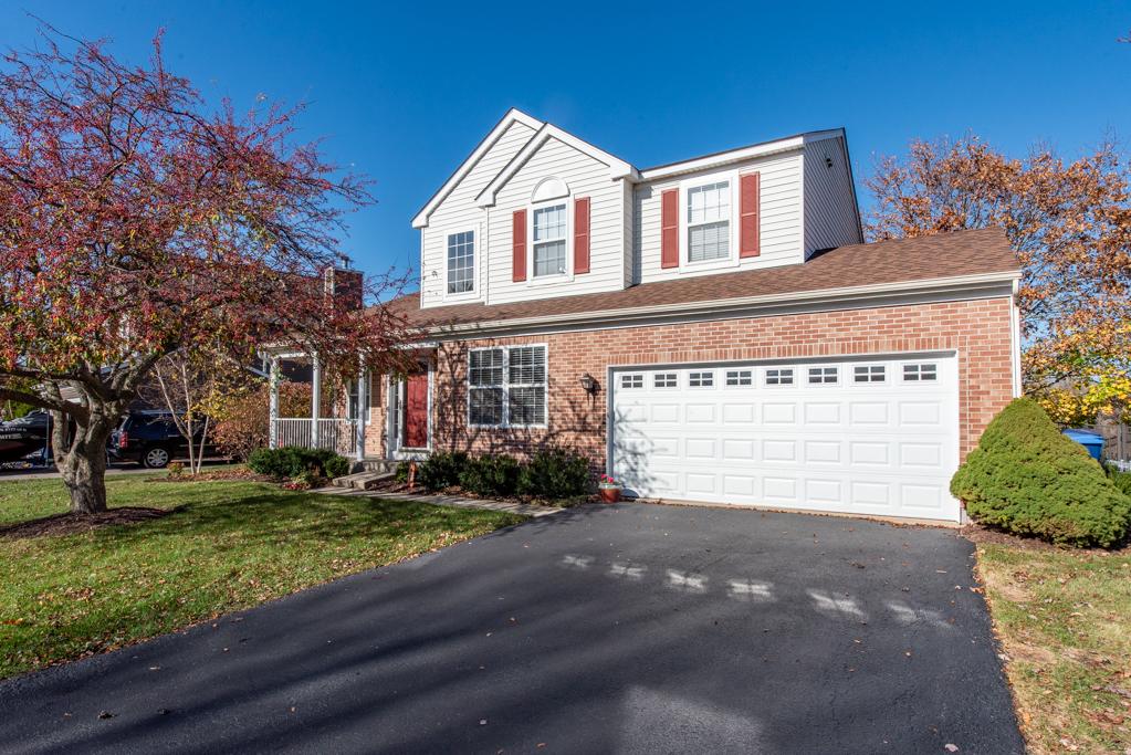 front of property with a garage and a front lawn