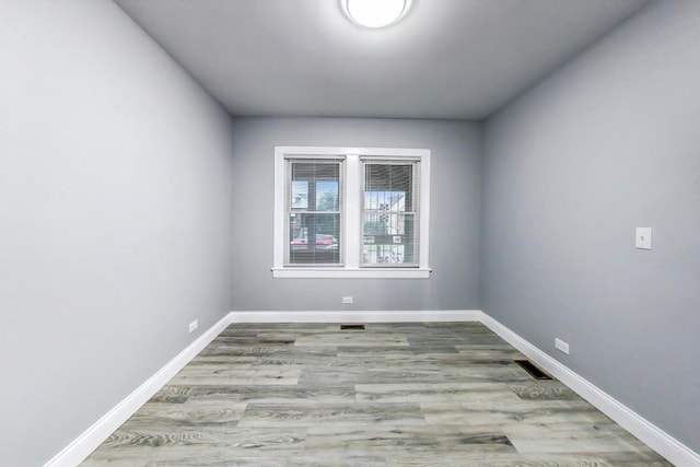 spare room with light hardwood / wood-style flooring