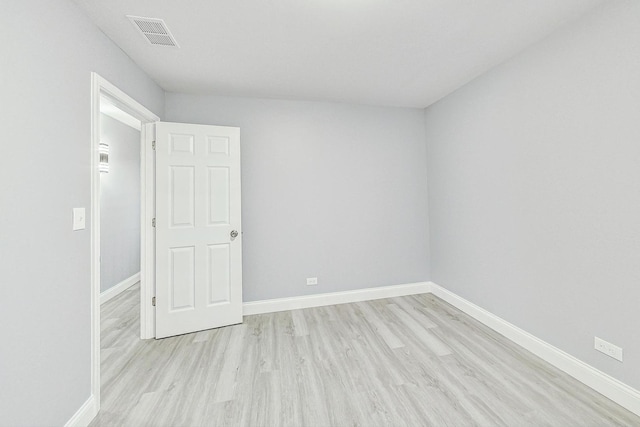 spare room featuring light wood-type flooring