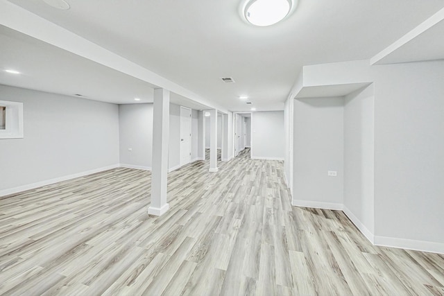 basement with light hardwood / wood-style floors