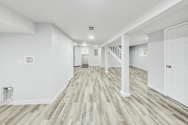 basement with light hardwood / wood-style floors