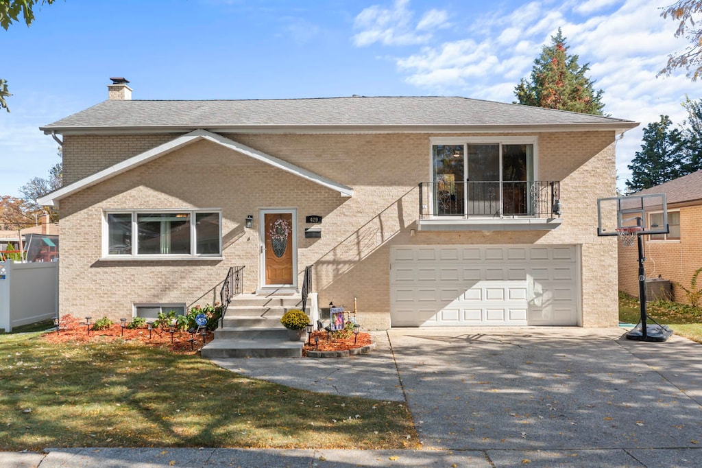 view of front of house with a front lawn and a garage