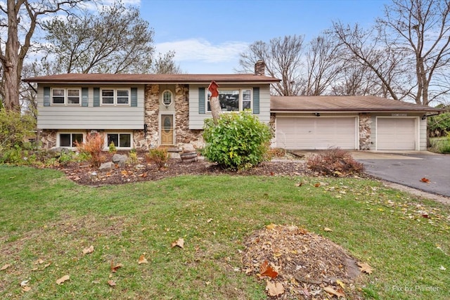 bi-level home featuring a front yard and a garage