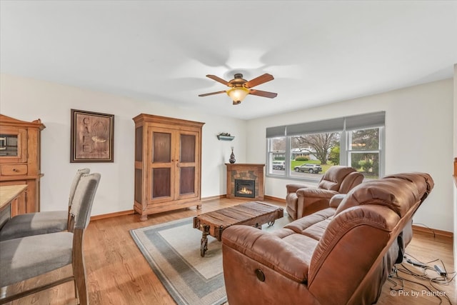 living room featuring ceiling fan and light hardwood / wood-style flooring