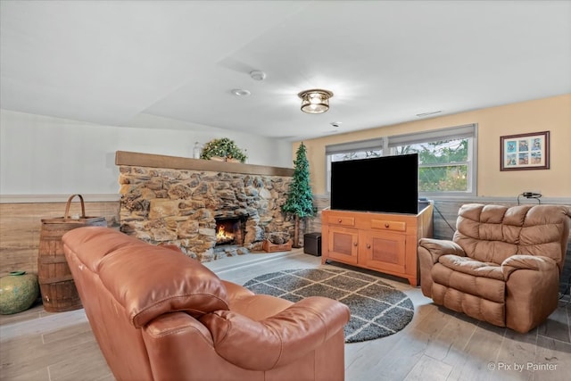 living room featuring light hardwood / wood-style floors and a fireplace