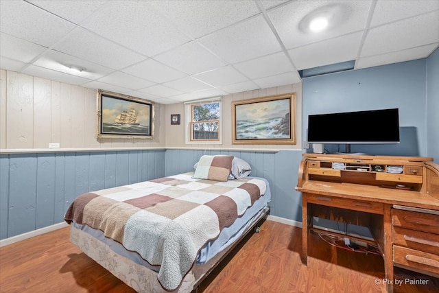 bedroom with hardwood / wood-style floors and a drop ceiling