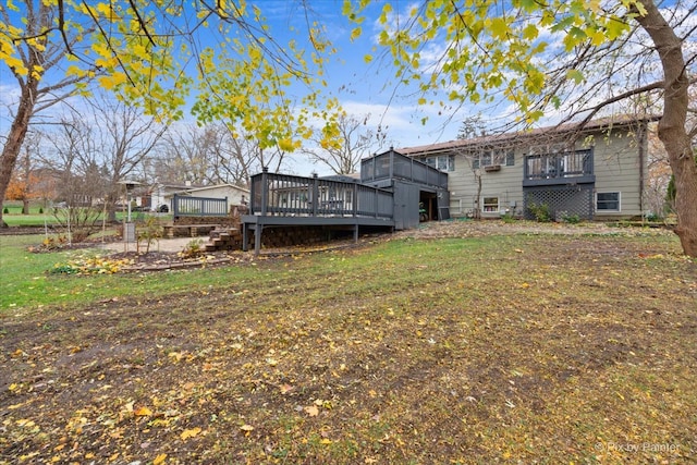 back of house with a deck and a lawn