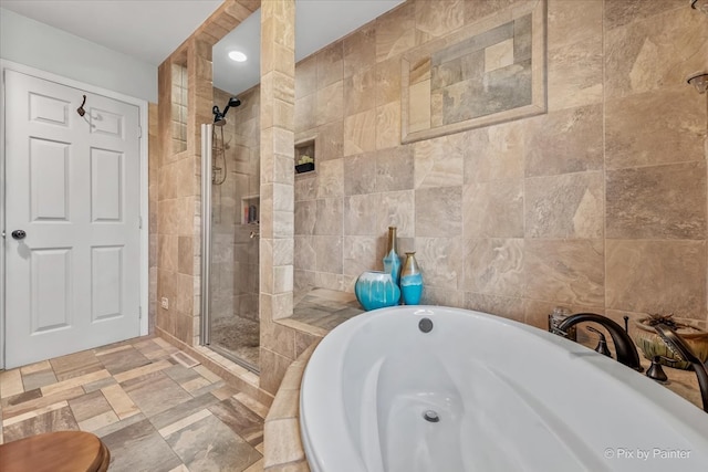 bathroom with plus walk in shower and tile walls