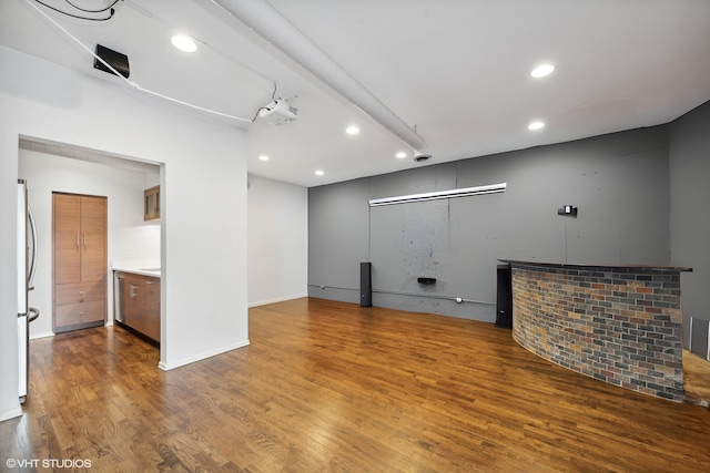 unfurnished room with hardwood / wood-style flooring and indoor bar