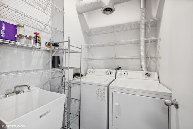 laundry area featuring separate washer and dryer and sink