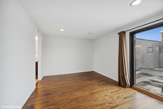 spare room featuring wood-type flooring