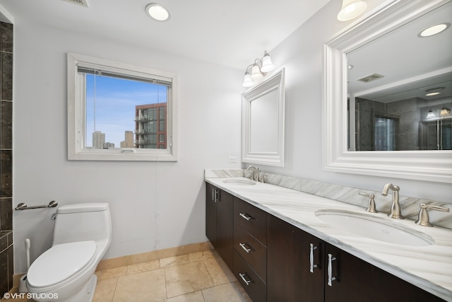 bathroom featuring tile patterned floors, vanity, and toilet